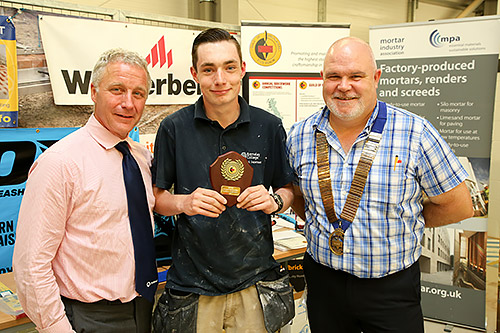 Junior section finals winner, Morgan Chambers, Barnsley College, is presented with his award by Tarmac Building Products’ Iain Betts (left) and guild president, Phil Vine Roberts.