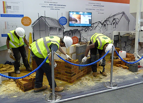 Apprentices from Grangewood Brickwork Services building demonstration corner details in brick and brickwork, arranged by MIA for the High Performance Housing feature at Ecobuild 2016, earlier in March