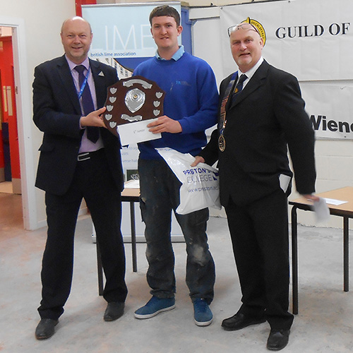 Junior winner, Matthew Cragg, is presented with his award by Kevin Burke, head of division, Preston College (left) and James Howe, president of the Guild Of Bricklayers (right),