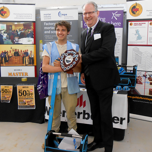 Fareham College principal and chief executive, Nigel Duncan, presents Rhys Matthews with his award as junior category winner.
