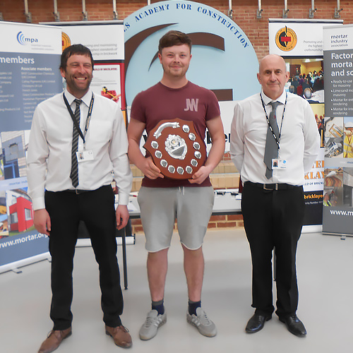 Junior winner, Arron Armstrong, Hartlepool College, being presented with his award by Gateshead College brick lecturers Mick Robinson (left) and Paul Briggs.
