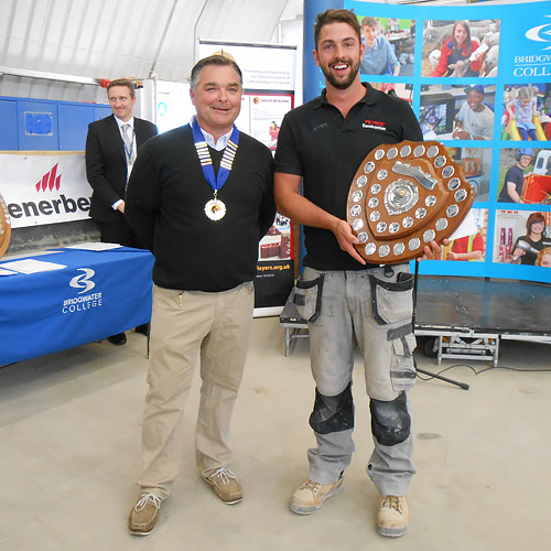 Andy Ballard, western competition secretary, presents his division’s junior winner, Ben Lawson (PETROC), with his award 