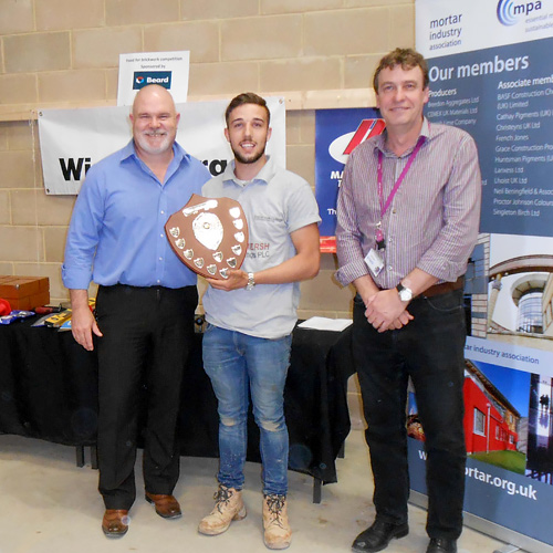Connor Honeyman of Barking and Dagenham College receives his award for the senior competition from Guild of Bricklayers president, Phil Vine-Roberts (left) and the Brooklands College head of construction, Neil Houldey