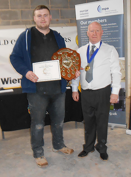 Winner of the senior section of the Guild of Bricklayers north west regional competition, Jordan Ireland, receives his awards from guild vice president, Kevin Harold.