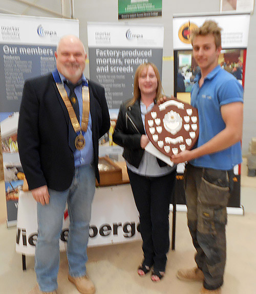 Stephen Tate of Sussex Downs College receives his senior category award from president of the Guild of Bricklayers, Phil Vine Roberts and Veronica Diett, wife of Kevin Diett, lecturer in charge of brickwork at Sussex Downs College, who died last year.